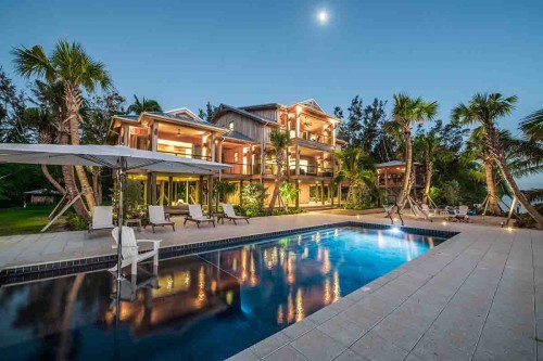 Florida House with full moon rising over pool and home